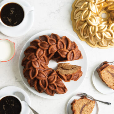 Banana bread Bundt cake baked in the Laurel Wreath Bundt Pan in a morning cofee scene overhead