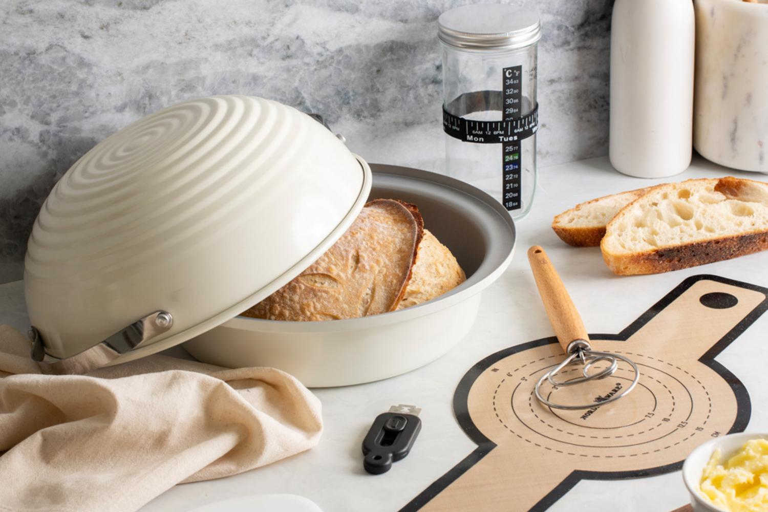 Simply Sourdough Bread Baking Kit on the counter with perfectly cooked bread inside of the pan.