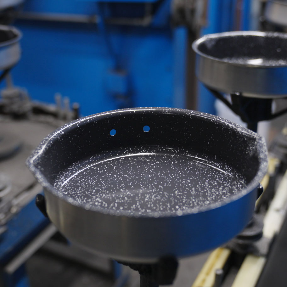 Image of cookware pans being coated with ceramic nonstick coating