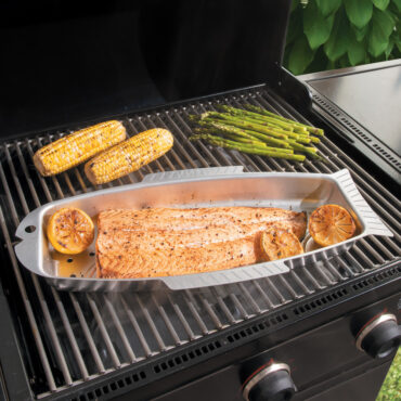 naturals fish and seafood griller on grill with salmon, corn cobs and asparagus