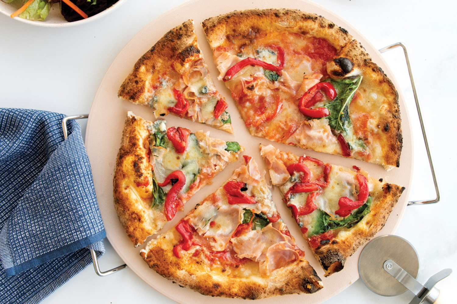 13 Inch Pizza Stone Set with a margherita pizza with red peppers baked on it. 