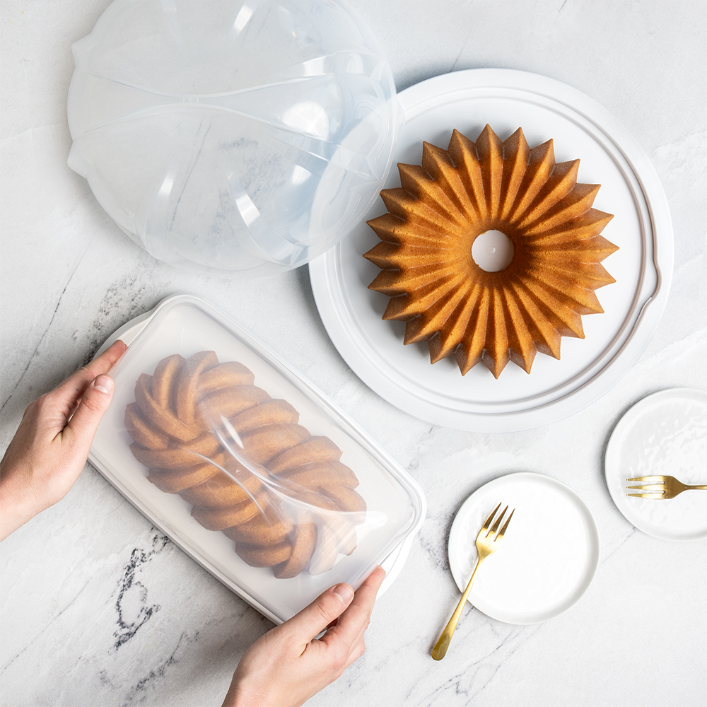 Overhead image of New white Loaf Cake Keeper with loaf cake and Bundt Cake Keeper with Bundt cake on kitchen counter