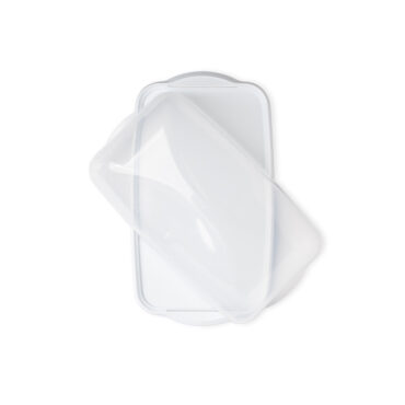 rectangular loaf cake keeper in white color with clear lid, plastic storage container, lid partially off, overhead
