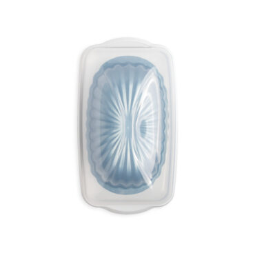 fluted loaf pan in loaf keeper with lid closed on white background