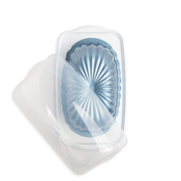 fluted loaf pan in loaf keeper with lid partially off on white backgroud