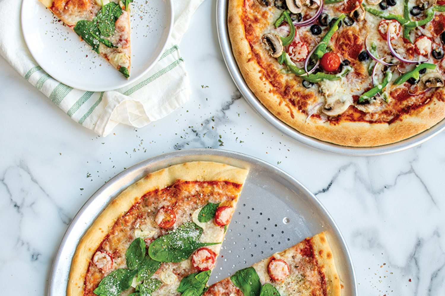 Traditional and Crisper Pizza Pan Set with pizza on them. 