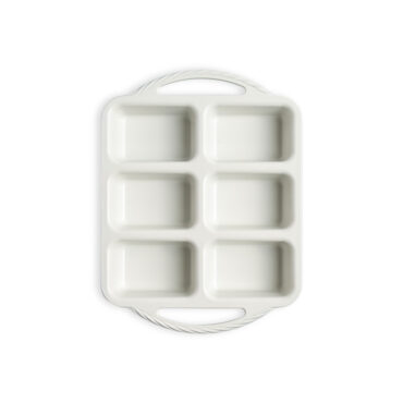 overhead view of aluminum mini loaf pan with 8 rectangular cavities showing white ceramic nonstick finish