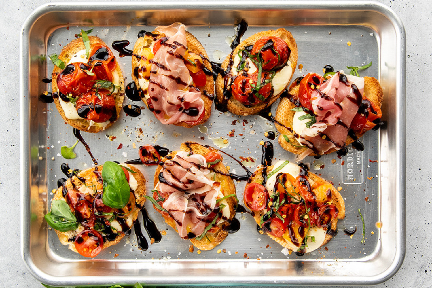 Naturals® Baker's Quarter Sheet Pan with bruschetta on it. 
