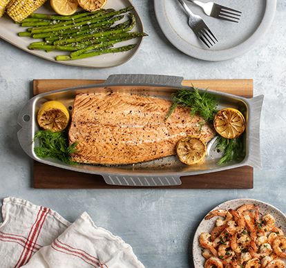 Image of fish griller in the shape of a fish with grilled salmon in a serving scene