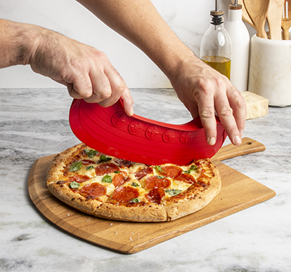 Image of man cutting pizza with Nordic Ware Rock the Boat Pizza Cutter in the shape of a boat