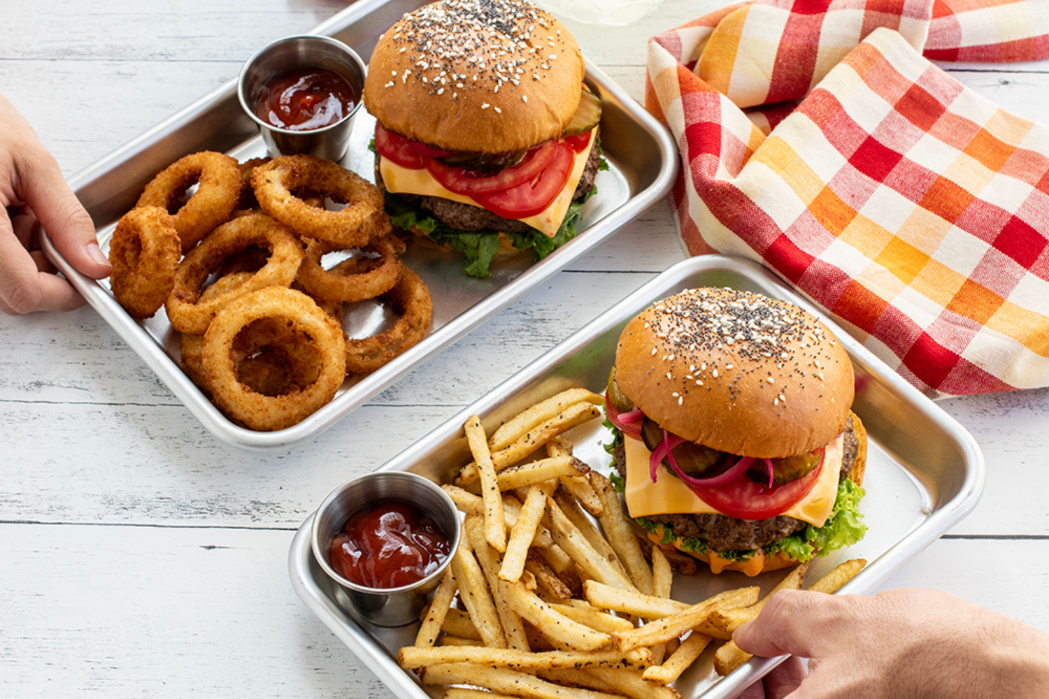Burgers served with fries and onion rings on Nordic Ware Burger Trays. 