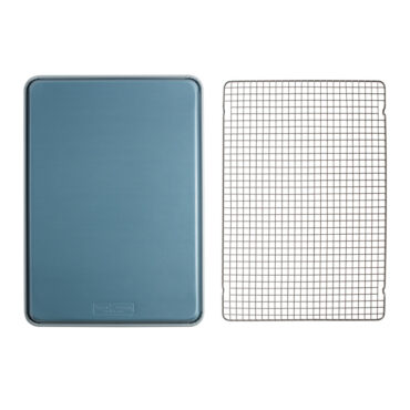 overhead showing exterior of brilliant big sheet pan next to cooling rack on white background