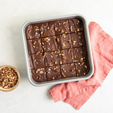 overhead of brilliant 9in square cake pan with brownies topped with nuts