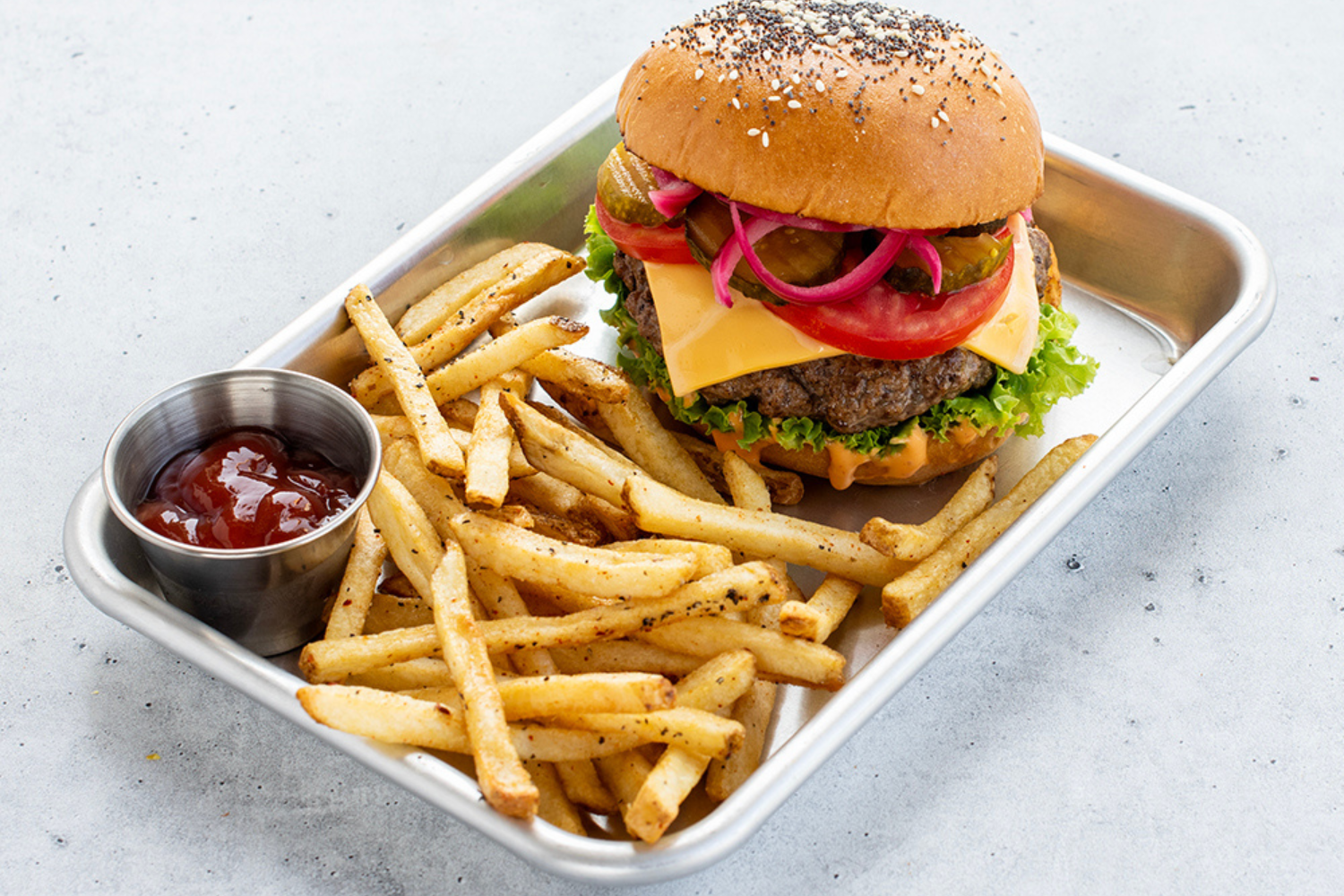 Assembled burger with fries on a Nordic Ware burger tray. 