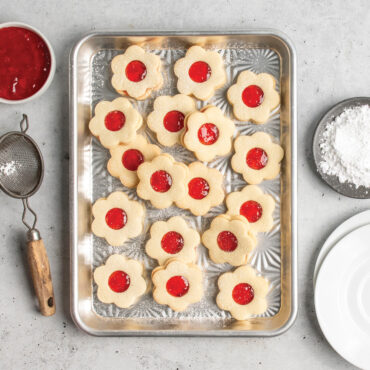 overhead of jam-filled novelty shaped cookies on starburst quarter sheet pan