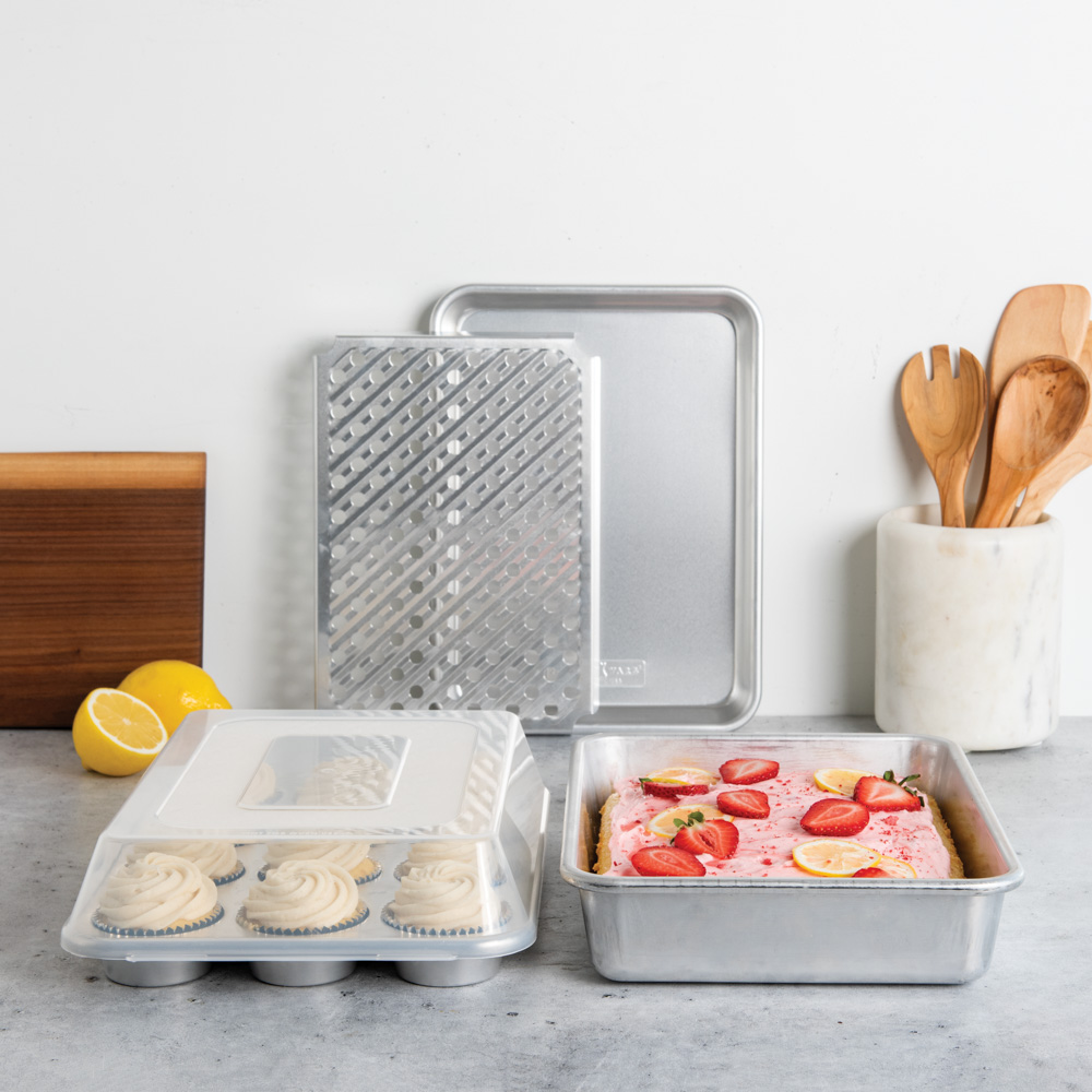 Image of Nordic Ware's new Naturals Bakeware 5 Piece Bake and Store Set in kitchen lifestyle scene with cupcakes and a sheet cake