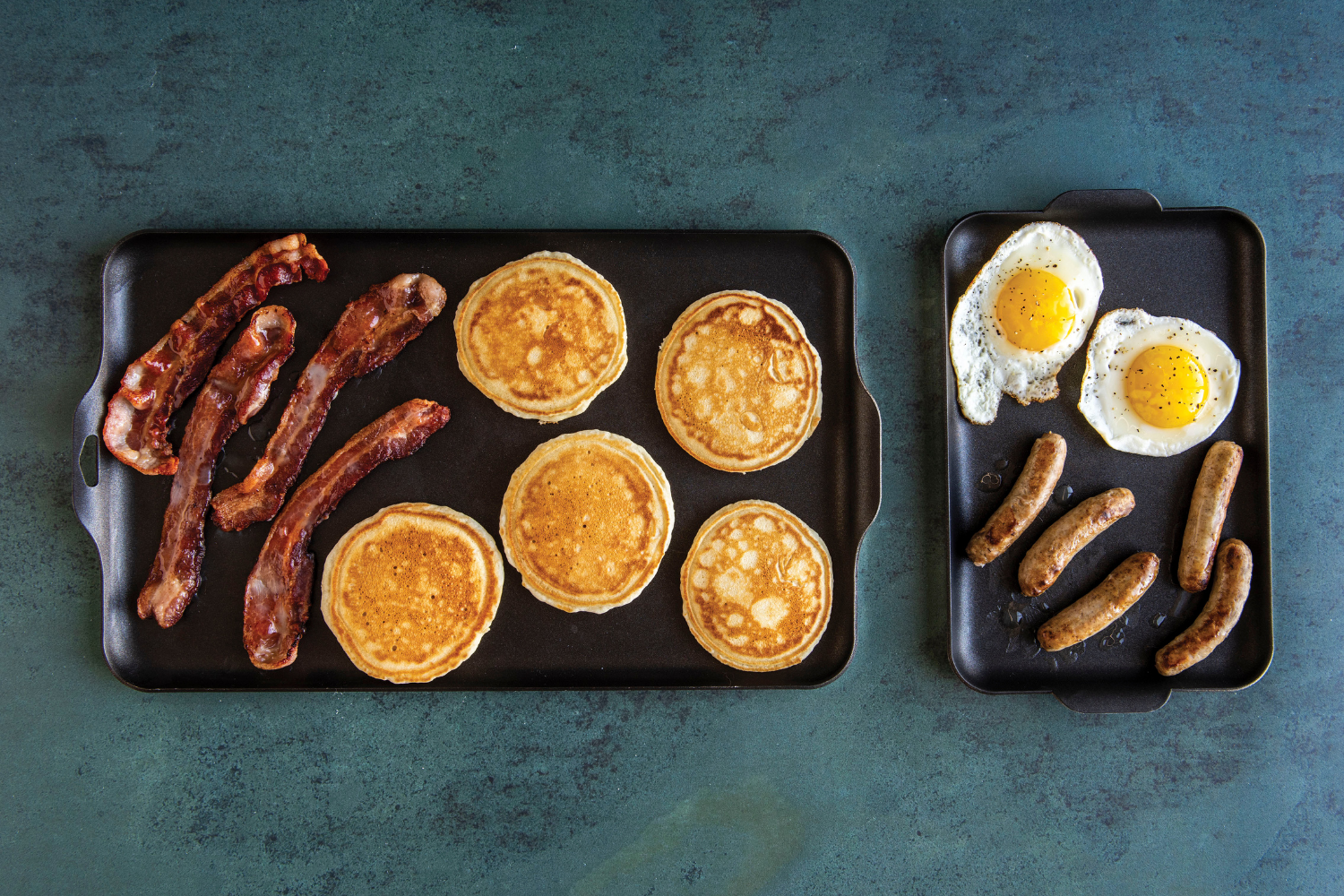 Two Burner Griddle King and Mini Griddle side by side with cooked breakfast foods on them. 