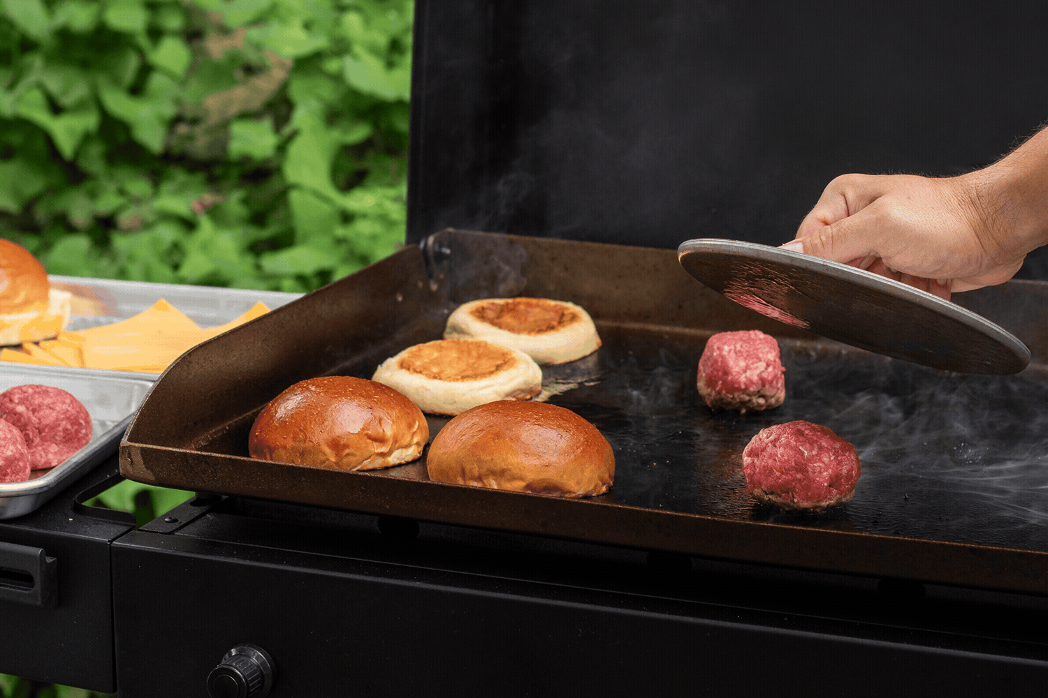 Gif of a Nordic Ware Heavyweight Grill Press smashing a burger patty on a griddle. 