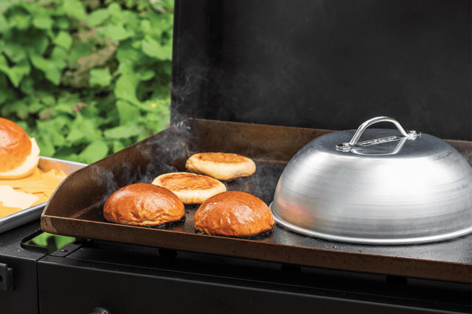 Gif of steaming buns on a griddle using the Nordic Ware High Dome Grill Lid.
