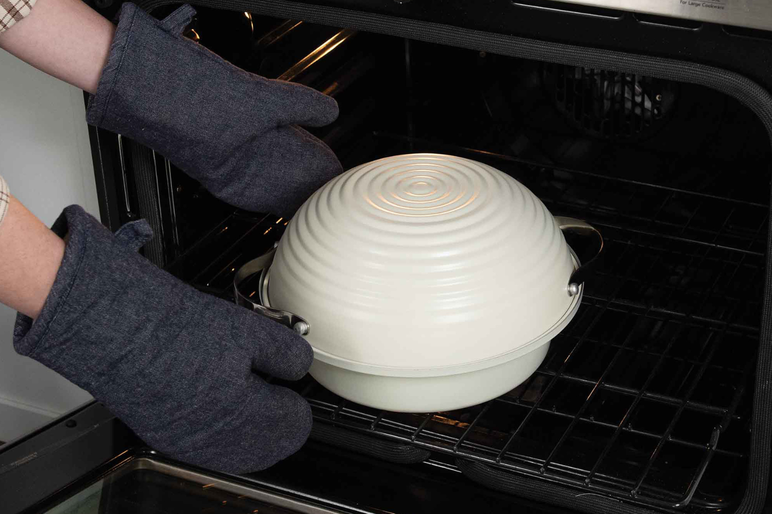Removing a Simply Sourdough Bread Baker from the oven.