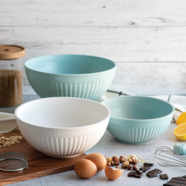 3 piece prep and serve mixing bowl set staged on countertop with various baking ingredients and accessories