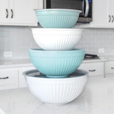 8 piece covered bowl set stacked on a a marble countertop in a home kitchen