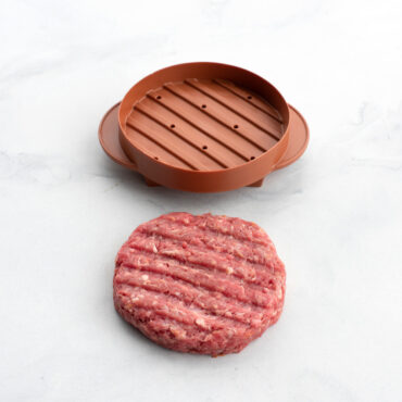 ribbed side of round stuffed burger press part staged with shaped hamburger meat with pressed lines