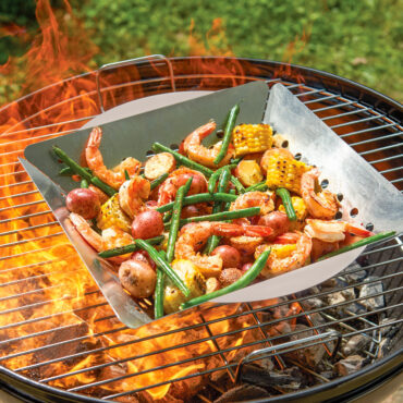 nordic ware grill basket being cooked on grill with shrimp and assorted veggies