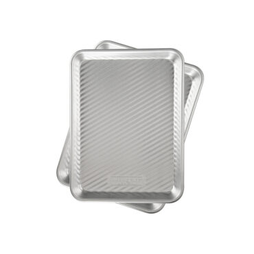 set of 2 nordic ware grill and serve trays with ribbed surface on white backround