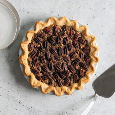 overhead of pecan pie in nordic ware vintage starburst pie pan