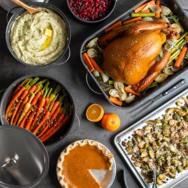Thanksgiving table group shot with Dutch Oven filled with mashed potatoes