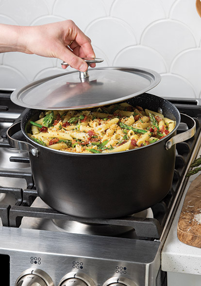 Image of 6 Qt Dutch Oven on the stovetop with cooked pasta meal