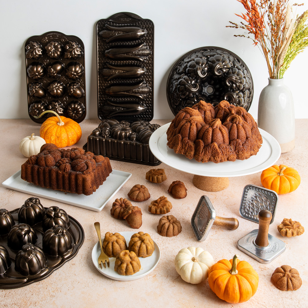 Image of Nordic Ware fall bakeware favorites such as Bundt cakes, loaf cakes, cookie stamps and more in Fall scene