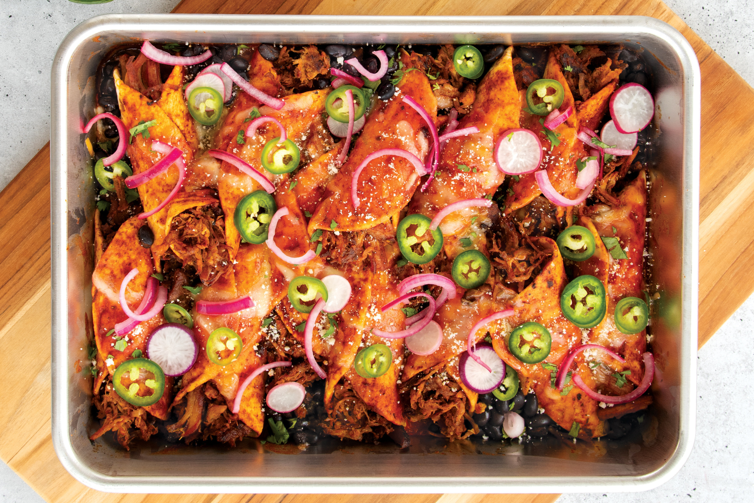 Baked enchiladas in the Naturals® 9" x 13" Rectangular Cake Pan 