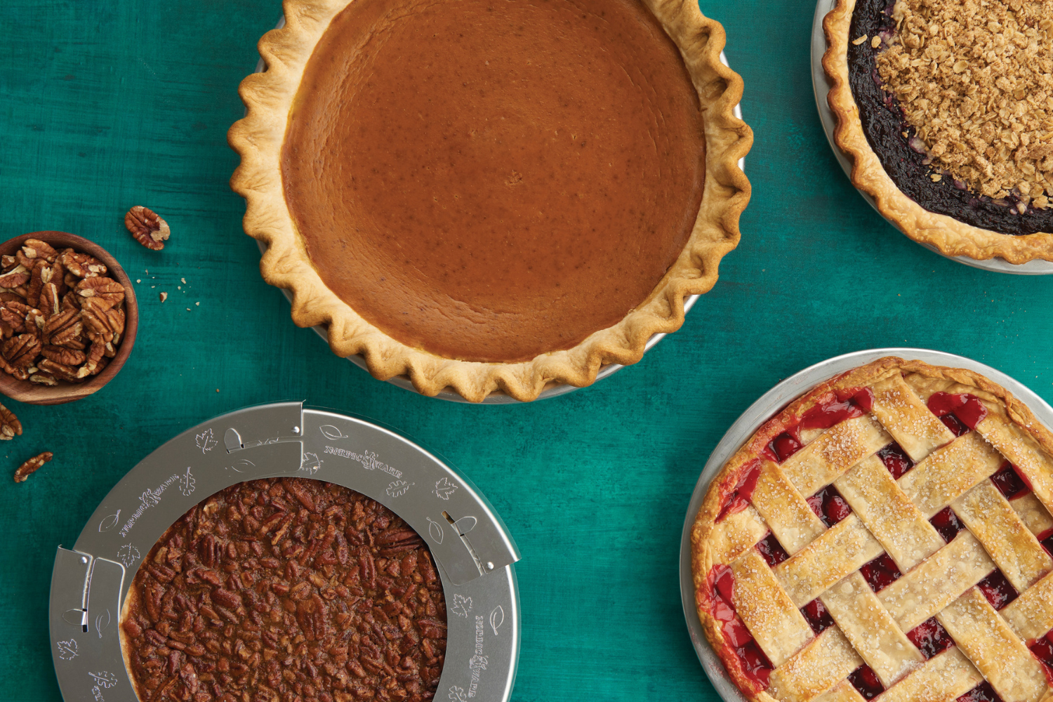 Various pies made in Nordic Ware Pie pans including a pumpkin, berry, cherry, and pecan pie. 