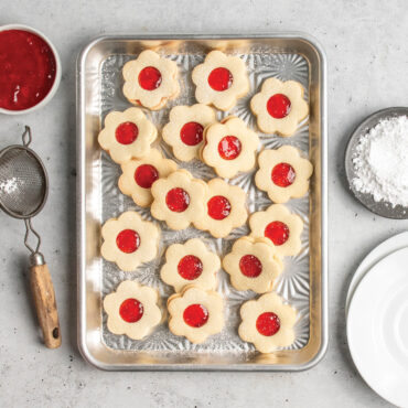 overhead of jam-filled novelty shaped cookies on starburst quarter sheet pan