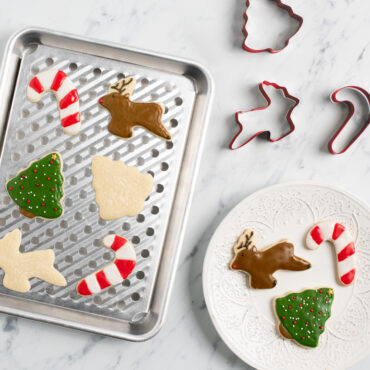 nordic ware quarter sheet with multi rack and red holiday cookie cutters with decorated cookies