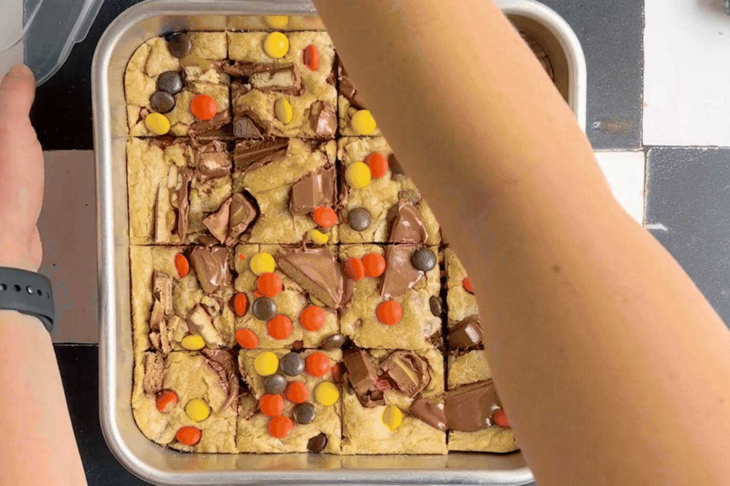 Lid being added to Halloween Candy Cookie Bars baked in the Brownie Buddy Baking Set and transported away. 